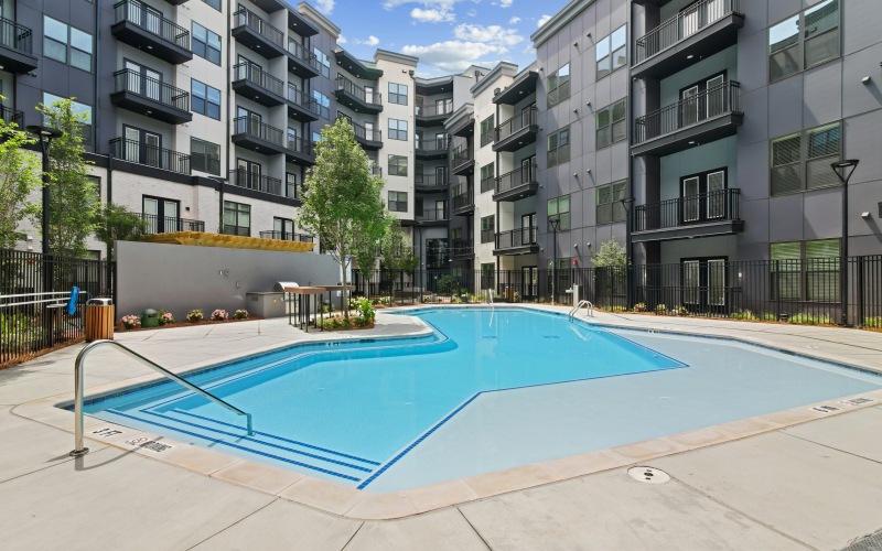 Resort-style swimming pool with sundeck at The Hawkins luxury apartments in Chamblee	